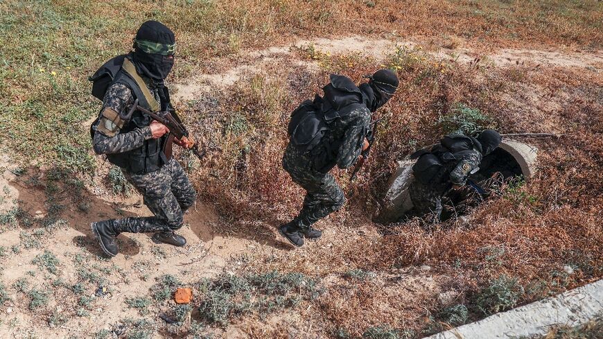 The Gaza Strip is run by Hamas, but it is also home to the Islamic Jihad militant group, whose personnel are pictured entering a tunnel in the Palestinian enclave on Sunday
