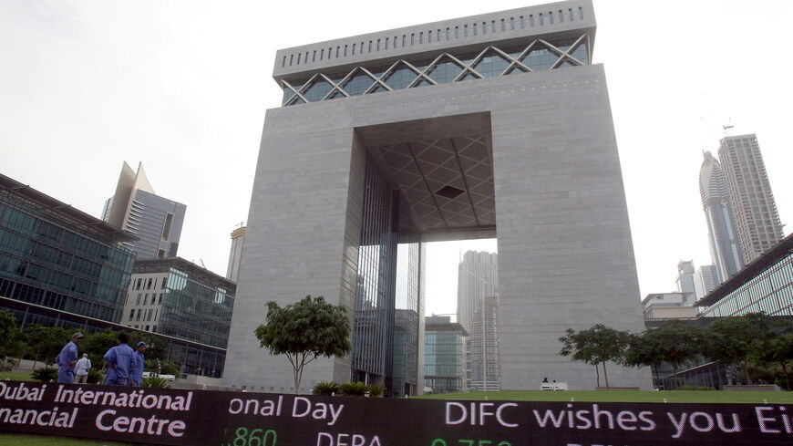 Workers stand outside the Dubai International Financial Center in the Gulf emirate on Nov. 29, 2009. 