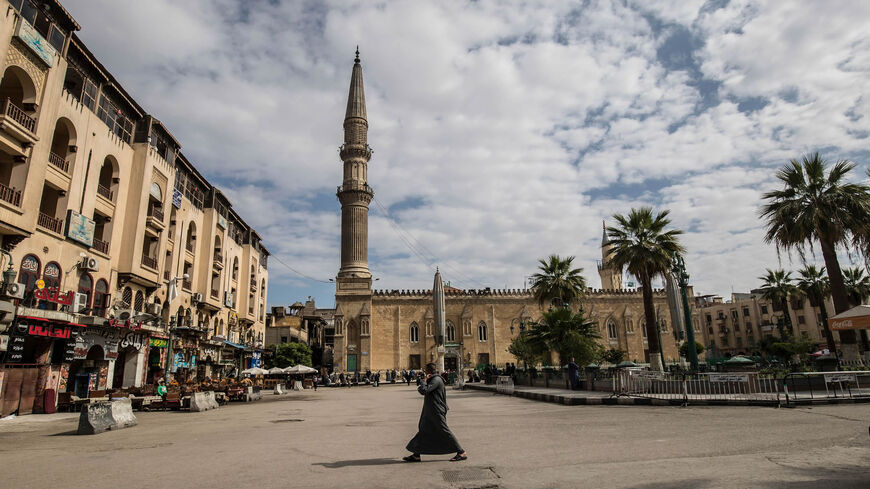 A man walks in the vicinity of the closed Al-Hussein Mosque, after the country's Muslim religious authorities decided to put the Friday prayers on hold in order to avoid gatherings and the spread of the coronavirus, Cairo, Egypt, March 20, 2020.