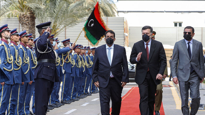Mohamed al-Manfi (L), head of Libya's presidency council, and new interim Prime Minister Abdul Hamid Dbeibah (R) arrive.