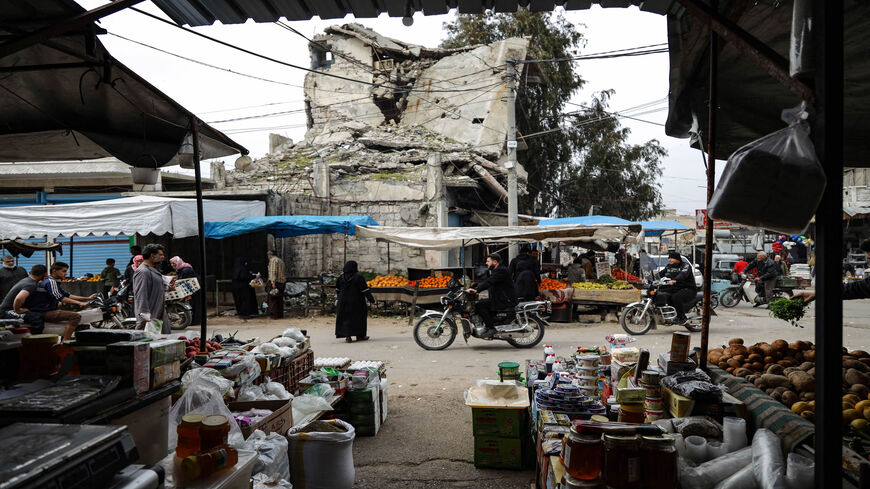 Syrians gather at a market as they prepare for the upcoming Muslim holy month of Ramadan, in the war-ravaged town of Ariha in the rebel-held northwestern Idlib province, Syria, March 31, 2022.
