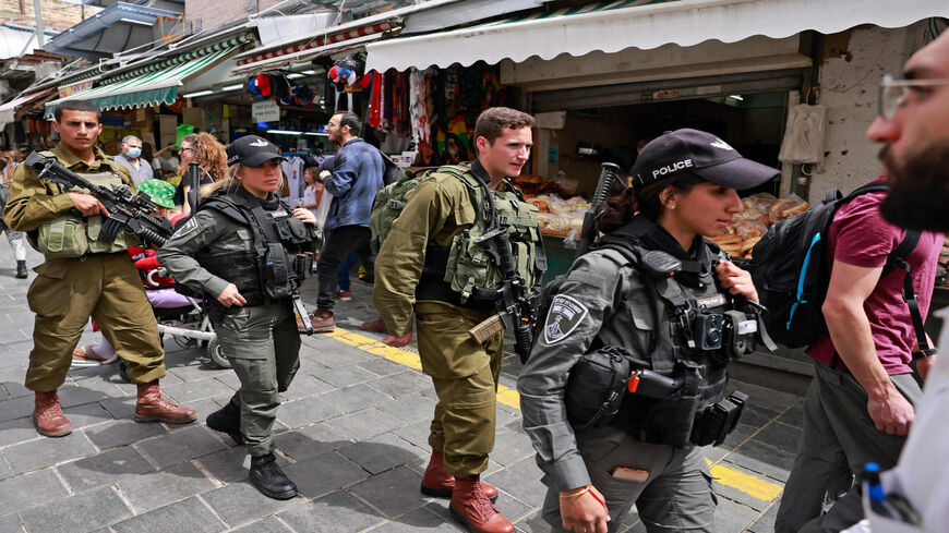 Israeli security forces patrol Jerusalem's Mahane Yehuda market, a day after a Palestinian gunman killed two Israeli men and wounded several others in Tel Aviv, April 8, 2022.