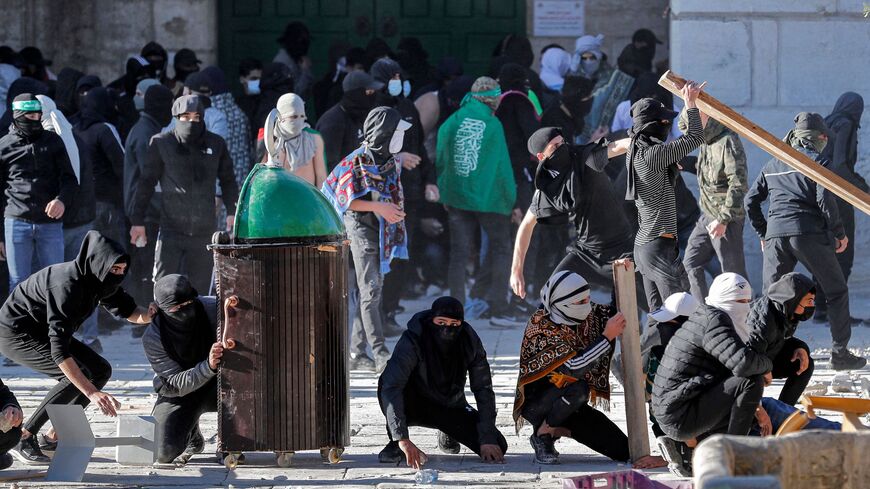 Palestinian demonstrators clash with Israeli police at Jerusalem's Al-Aqsa Mosque compound on April 15, 2022.