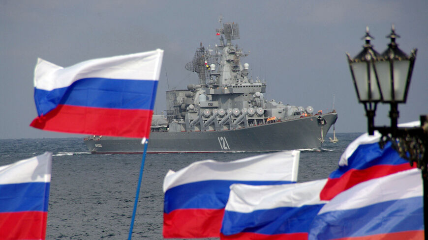 Pro-Russian supporters wave flags as they welcome missile cruiser Moskva.