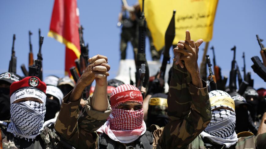 Members of various Palestinian factions pose for a picture during a demonstration to mark Quds Day in Gaza City on July 10, 2015. 