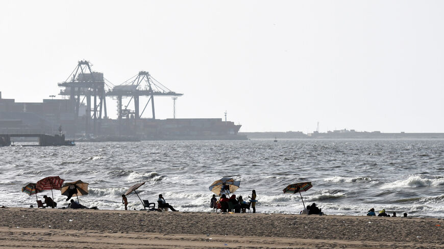 Egyptians sit under umbrellas on the beach in the port city of Alexandria, Egypt, Sept. 12, 2015.