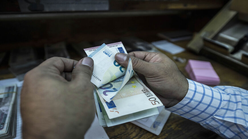 An employee counts banknotes at a currency exchange shop, Cairo, Egypt, Nov. 3, 2016.
