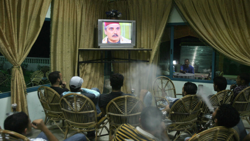 Palestinian men smoke waterpipes as they watch the Syrian drama series "Bab al-Hara" ("The Door to the Neighborhood") in a cafe, Gaza City, Gaza Strip, Oct. 8, 2007.