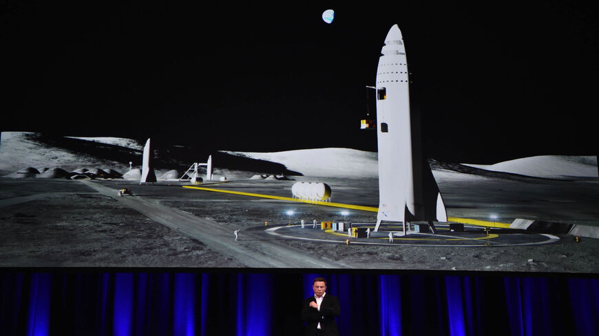 Billionaire entrepreneur and founder of SpaceX Elon Musk speaks below a computer-generated illustration of his new rocket at the 68th International Astronautical Congress 2017, Adelaide, Australia, Sept. 29, 2017.