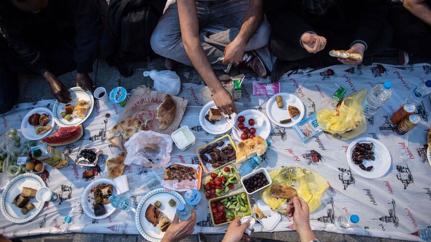 People break their fast on May 16, 2018, near Taksim Square in Istanbul.
