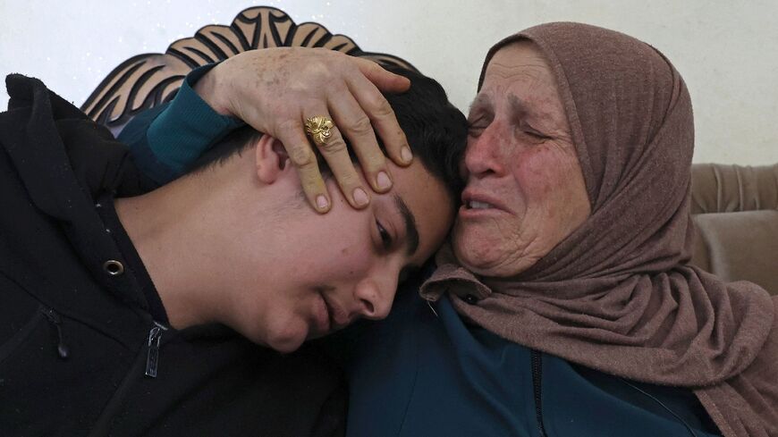 Houria Sabatien, whose daughter Ghada was shot by an Israeli soldier on April 10, mourns with her grandchild 