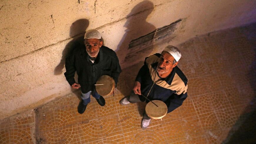 Traditional dawn awakeners known as 'Musaharati' beat drums and chant religious songs to wake up Muslims before sunrise for the 'suhur' meal before the day's fast during the holy month of Ramadan