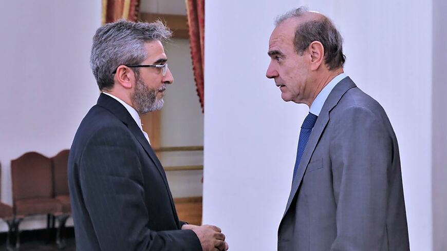A handout picture provided by the Iranian foreign ministry shows Iranian Deputy Foreign Minister and Chief nuclear negotiator Ali Bagheri welcoming EU diplomat Enrique Mora, who arrived in Tehran for talks on restoring Iran's nuclear deal