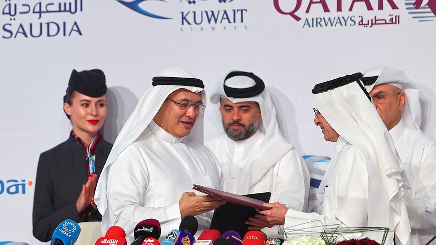 Facing growing pressure to cope with the World Cup football tournament, Qatar Airways chief executive Akbar Al Baker (R) said the national airline would halt some routes to countries not participating during the tournament