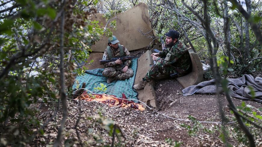 Fighters affiliated with the Hayat Tahrir al-Sham (HTS) jihadist group take a position in the mountainous northern countryside of Syria's northwestern Latakia province on April 23, 2022