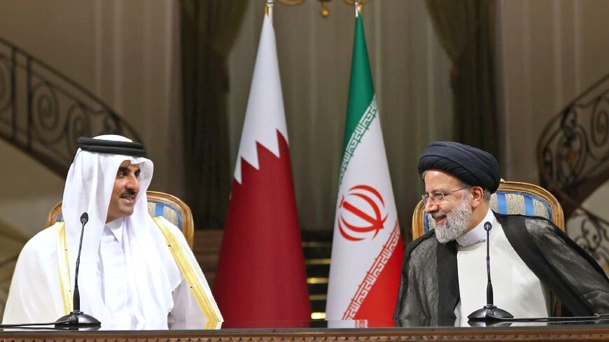 Iran's President Ebrahim Raisi (R) holds a press conference with visiting Qatari Emir Sheikh Tamim bin Hamad Al-Thani -- the Gulf state has added the Iran nuclear dispute to a list of diplomatic issues in which it has quietly mediated