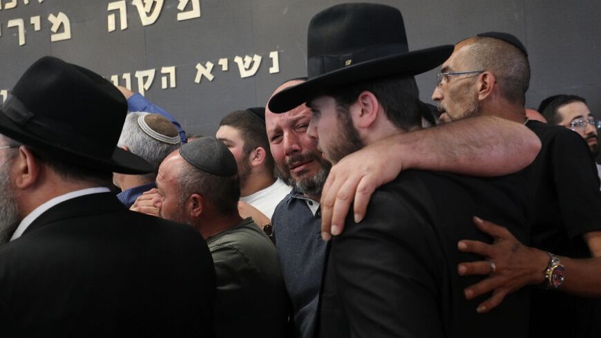 Relatives and friends mourn at a cemetery in Lod during the funeral of Oren Ben Yiftach, a 35-year-old Israeli killed in an axe attack 