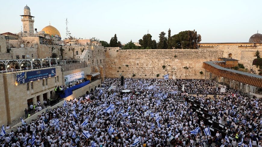 Thousands of flag-waving Israelis marched into the Muslim quarter of Jerusalem's Old City during a nationalist procession that culminated at the Western Wall below the Al-Aqsa mosque