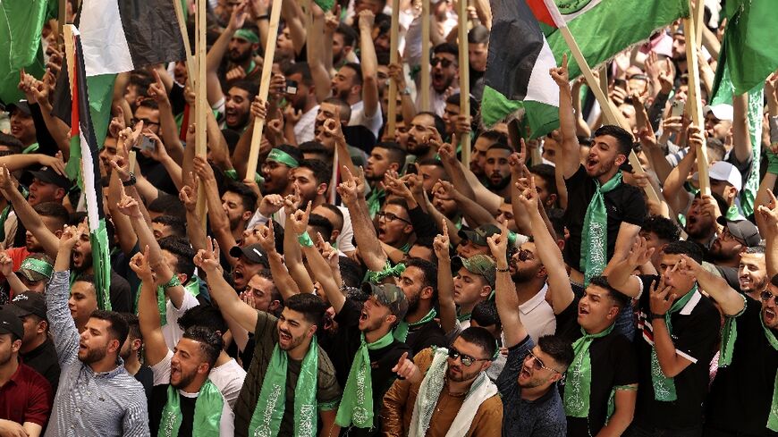 Students who support Hamas wave flags ahead of council elections at Birzeit University