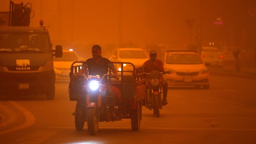 Vehicles drive along a road during a severe dust storm in Iraq's capital Baghdad