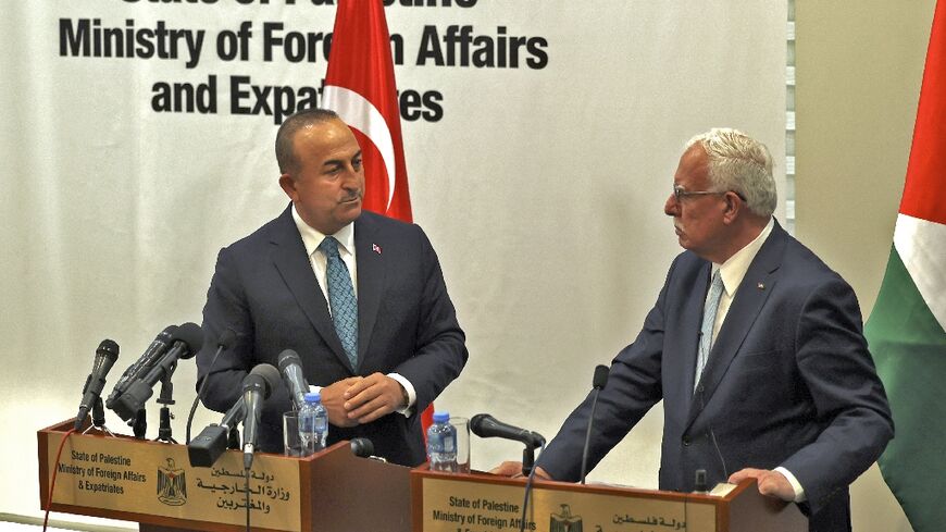 Turkey's top diplomat Mevlut Cavusoglu (L) attends a news conference in Ramallah with Palestinian foreign minister Riyad al-Maliki (R)