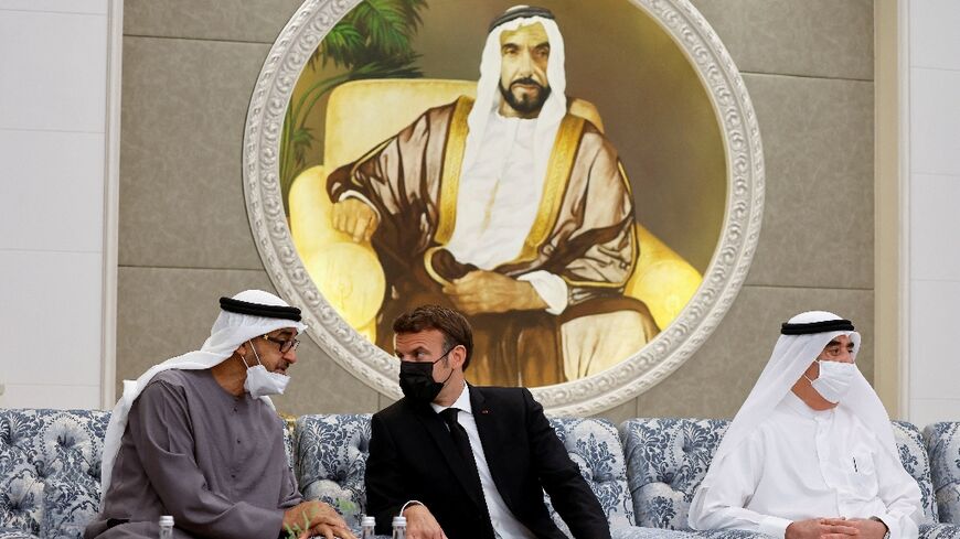 French President Emmanuel Macron, at the centre, meets the newly-elected president of the United Arab Emirates, Sheikh Mohammed bin Zayed Al Nahyan, on the left, at Al Mushrif Palace in Abu Dhabi on May 15, 2022