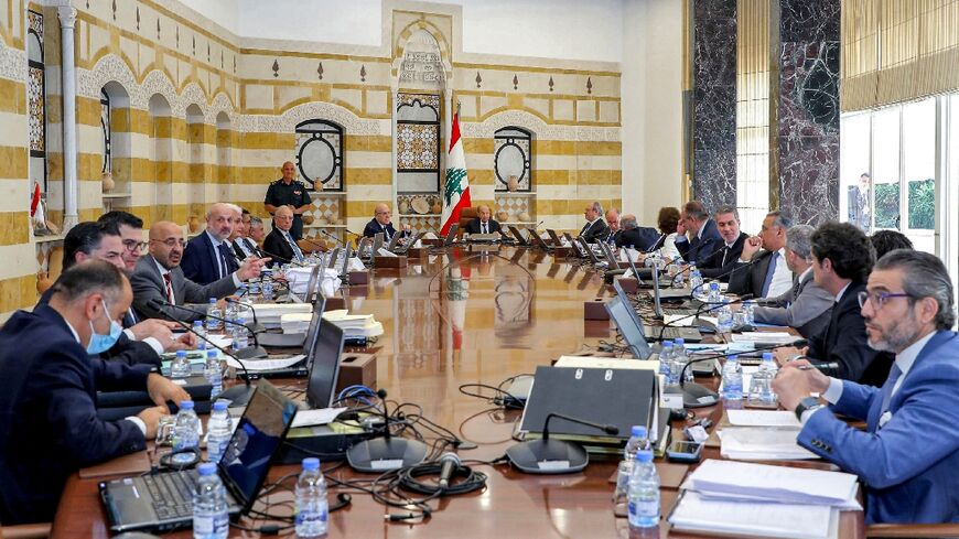 Lebanon's President Michel Aoun (C-R) and Prime Minister Najib Mikati (C-L) headed the outgoing government's final cabinet meeting at the governmental palace in the capital Beirut