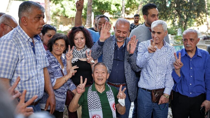 Kozo Okamoto (C), the only surviving member of a three-man Japanese Red Army commando that killed 26 people at Israel's Lod airport on May 30, 1972, gestures at a ceremony organised by Palestinian militants in Beirut
