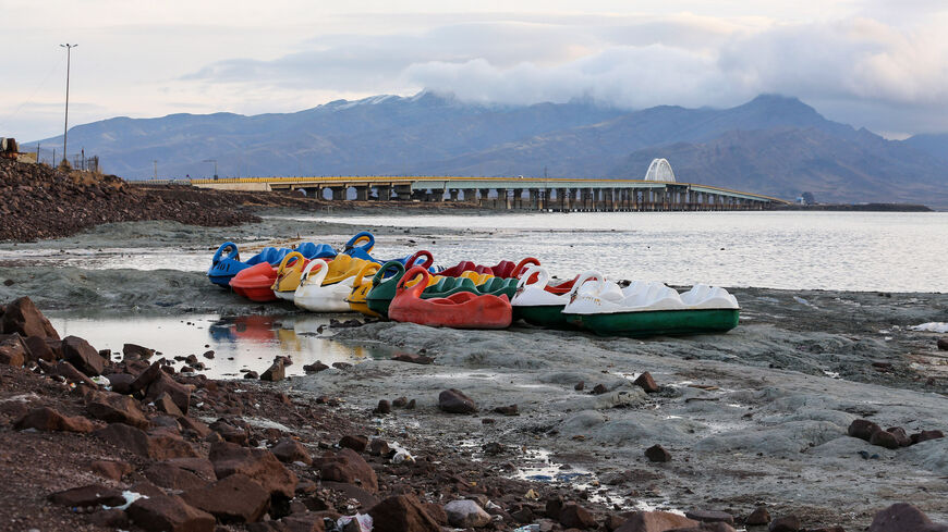 Recreational boats along the shore of the salt lake of Urmia and Shahid Kalantari causeway crossing it in Iran.