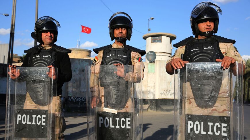 Iraqi riot police protect the Turkish embassy in Baghdad on February 18, 2021.