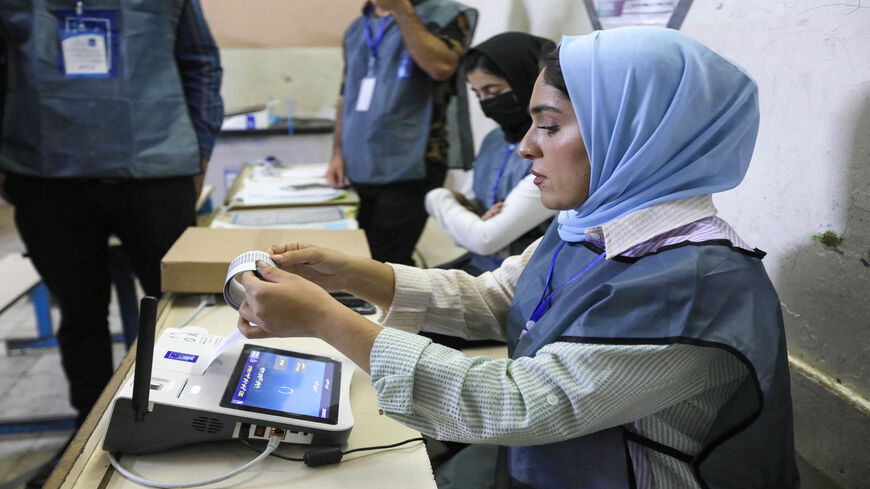Iraqi election officials conduct the electronic count of votes at a polling station in Erbil, Iraqi Kurdistan, Oct. 10, 2021.