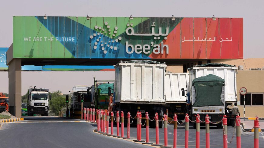 Trucks drive in and out of the Bee'ah waste management company in the Gulf emirate of Sharjah.