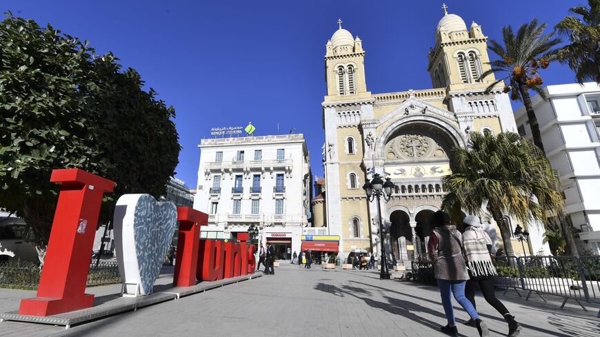 People walk past Saint-Vincent de Paul Cathedral on Habib Bourguiba Avenue in Tunis on Dec. 14, 2021.