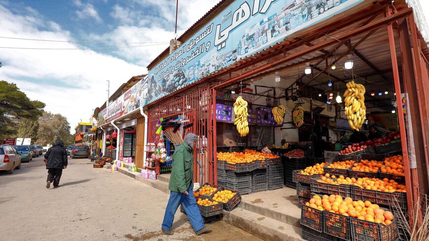A man walks outside a vegetable and fruit seller's shop in Libya's eastern town of Shahat, in the Jabal al-Akhdar (Green Mountain) region, on Feb. 10, 2022. 