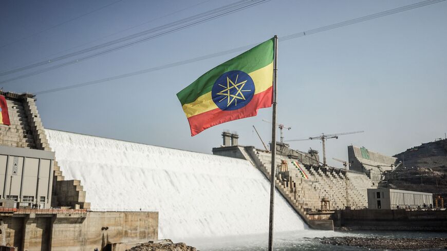 This general view shows an Ethiopian national flag flying infront of the Grand Ethiopian Renaissance Dam (GERD) in Guba, Ethiopia, on Feb. 19, 2022. 