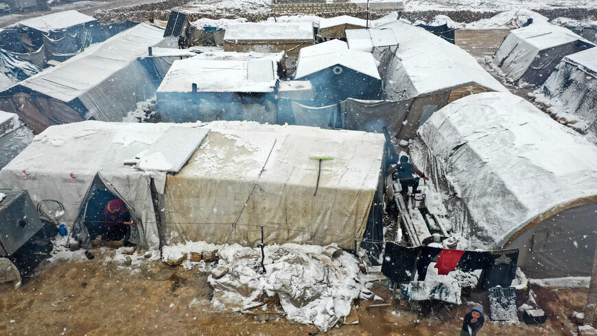 This aerial view shows tents covered in snow at a camp for internally displaced Syrians, near the town of Kafr Lusin, as a snow storm hit the region, at the border with Turkey in the rebel-held northwestern province of Idlib, March 13, 2022.
