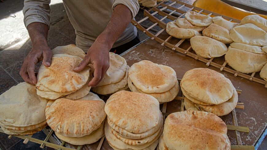 Egyptian men work in a bakery at a market in Cairo, on March 17, 2022. 