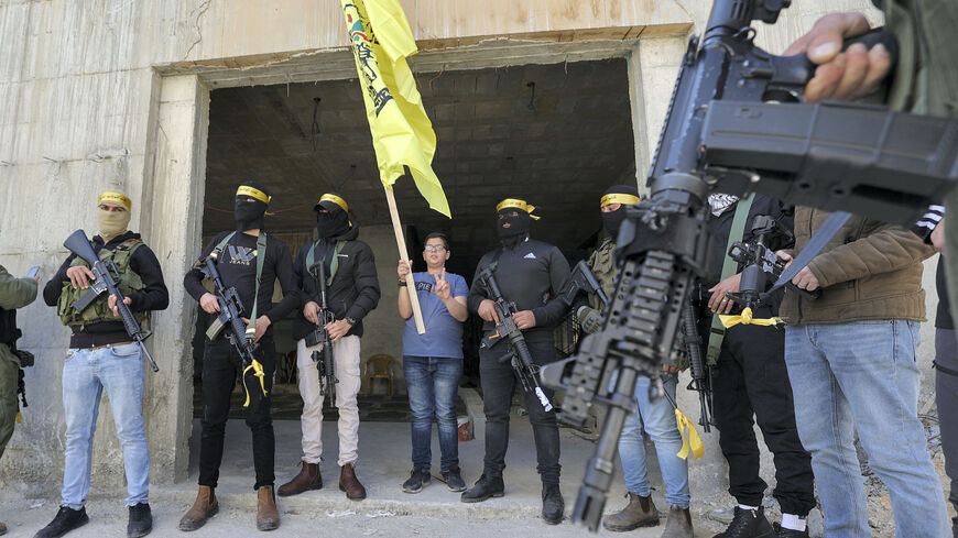 Members of the "Martyr Abu Ammar Brigades" (alias of Yasser Arafat), part of Al-Aqsa Martyr's Brigades faction affiliated with the Fateh movement, stand with small arms during the funeral of Islamic Jihad militant Chas Kamamji in his home village of Kafr Dan, west of Jenin in the occupied West Bank, on April 14, 2022.