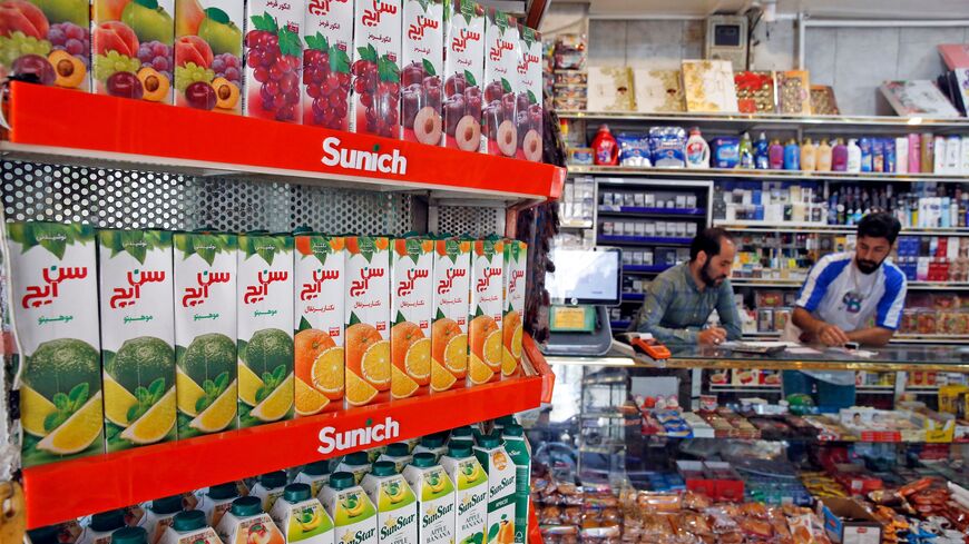 Iranians work at a food store in Tehran on May 13, 2021.