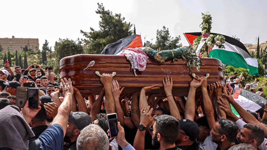 Palestinian mourners carry the casket of slain Al-Jazeera journalist Shireen Abu Akleh.