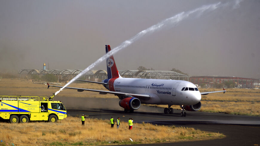 A firefighter truck celebrates with a water jet the first Yemen Airways flight in six years.