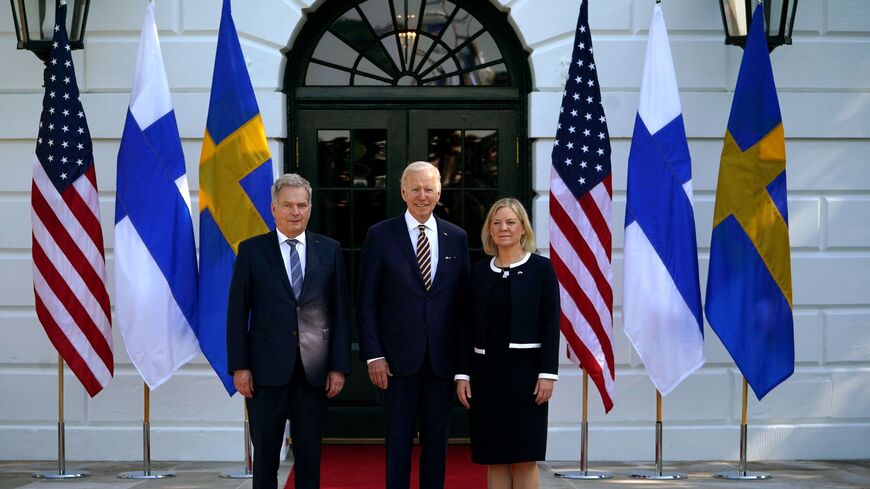US President Joe Biden (C) welcomes Finnish President Sauli Niinisto (L) and Swedish Prime Minister Magdalena Andersson.