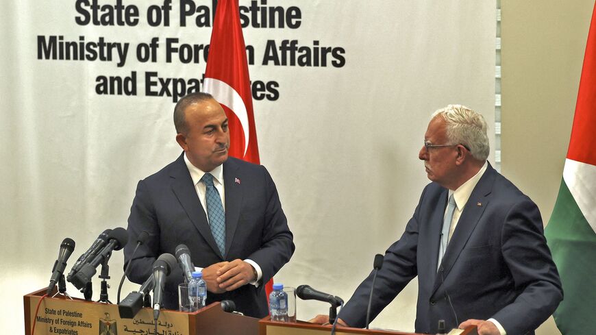 Palestinian Foreign Minister Riyad al-Maliki (R) and Turkish Foreign Minister Mevlut Cavusoglu attend a press conference after meeting in the city of Ramallah in the occupied West Bank on May 24, 2022. 