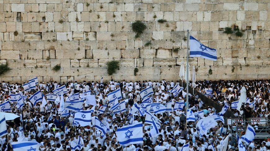 Demonstrators gather with Israeli flags at the Western Wall.