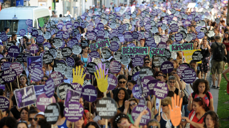 Turkish women hold placards and chant slogans as they march to Taksim Square during a demonstration against the government's plan to reduce the time limit for abortions.