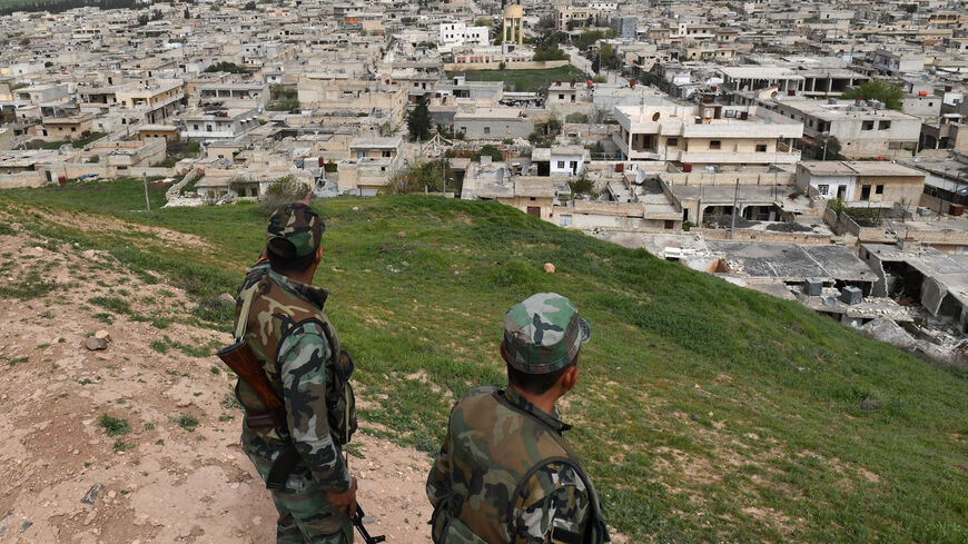 Syrian government forces monitor the northern Syrian town of Tel Rifaat on March 28, 2018.