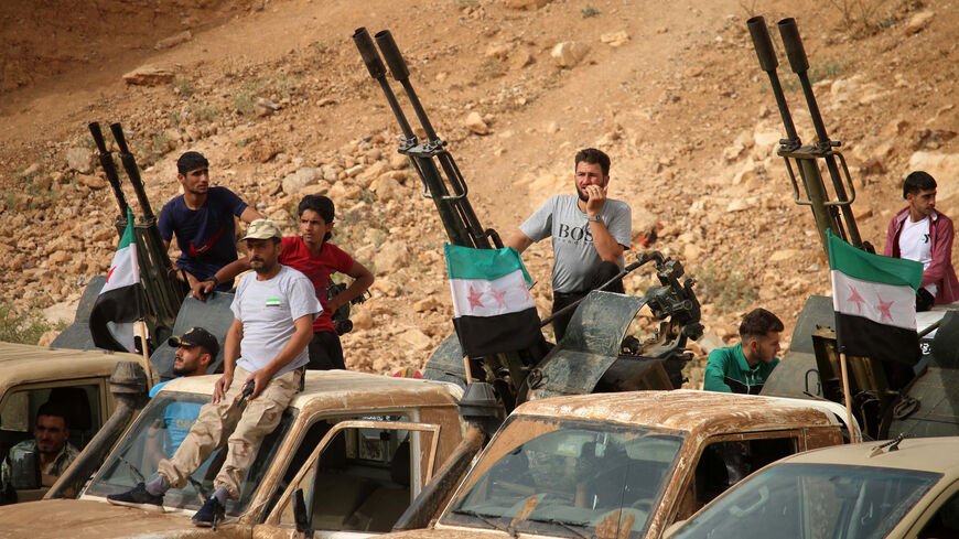 Syrian rebel fighters man anti-aircraft guns.