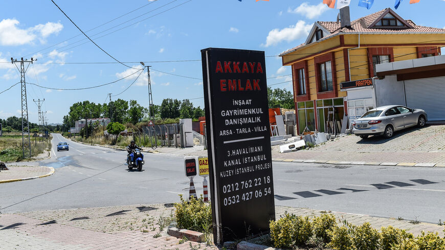 A real estate advertising offers apartments and houses with the view on the canal, in the small coastal village of Karaburun, near Istanbul, on June 12, 2018.  