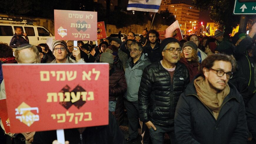 Israeli demonstrators carry placards against the extreme right-wing Kach movement founded by slain rabbi Meir Kahane in a March 2019 protest outside the residence of then prime minister Benjamin Netanyahu