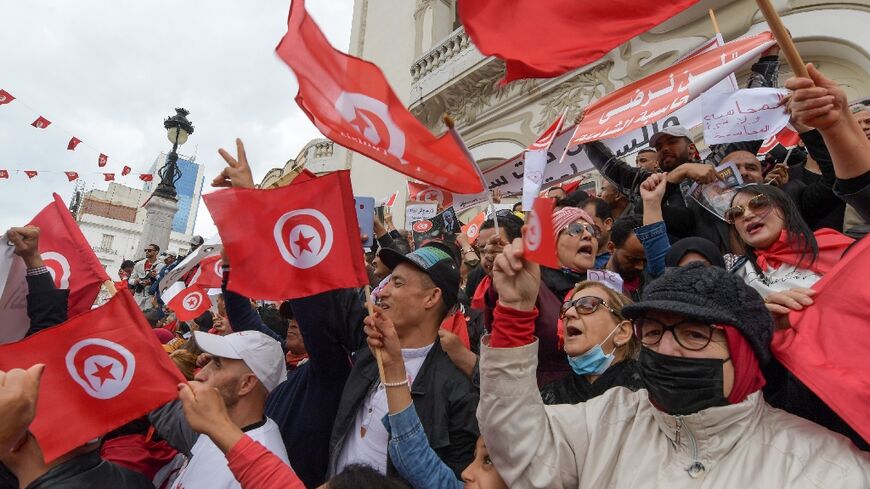 Tunisian demonstrators chant slogans and wave their country's national flag in support of President Kais Saied, in the capital Tunis